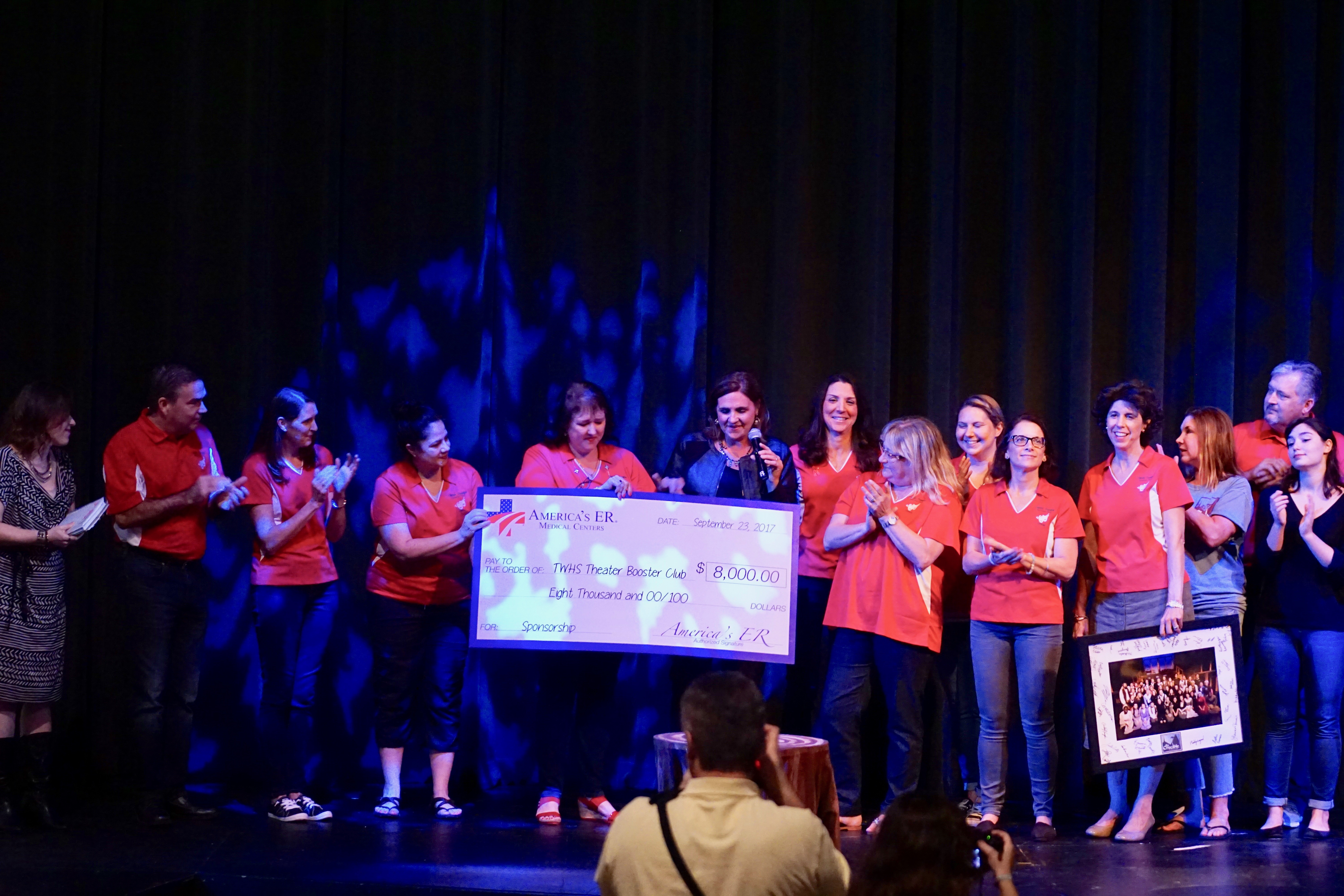 The Woodlands High School Theater 2017-2018 Sponsor America's ER - Magnolia & Woodlands is a proud sponsor of TWHS Theater for their 2017-2018 season! Because of the electives and after-school opportunities offered, The Woodlands High School has one of the most recognized theatre programs in the state of Texas. They are currently the Most Outstanding Thespian Troupe in Texas! TWHS Theater offers monthly improve shows that raise money towards local charities as well as full production shows several times a semester. Check out their calendar and be sure to catch an upcoming production with these talented students! http://www.twhstheater.com Photo: America’s ER Director of Marketing & Public Relations, Alisann Schweiker, presents an $8,000 big check to TWHS Theater Department.