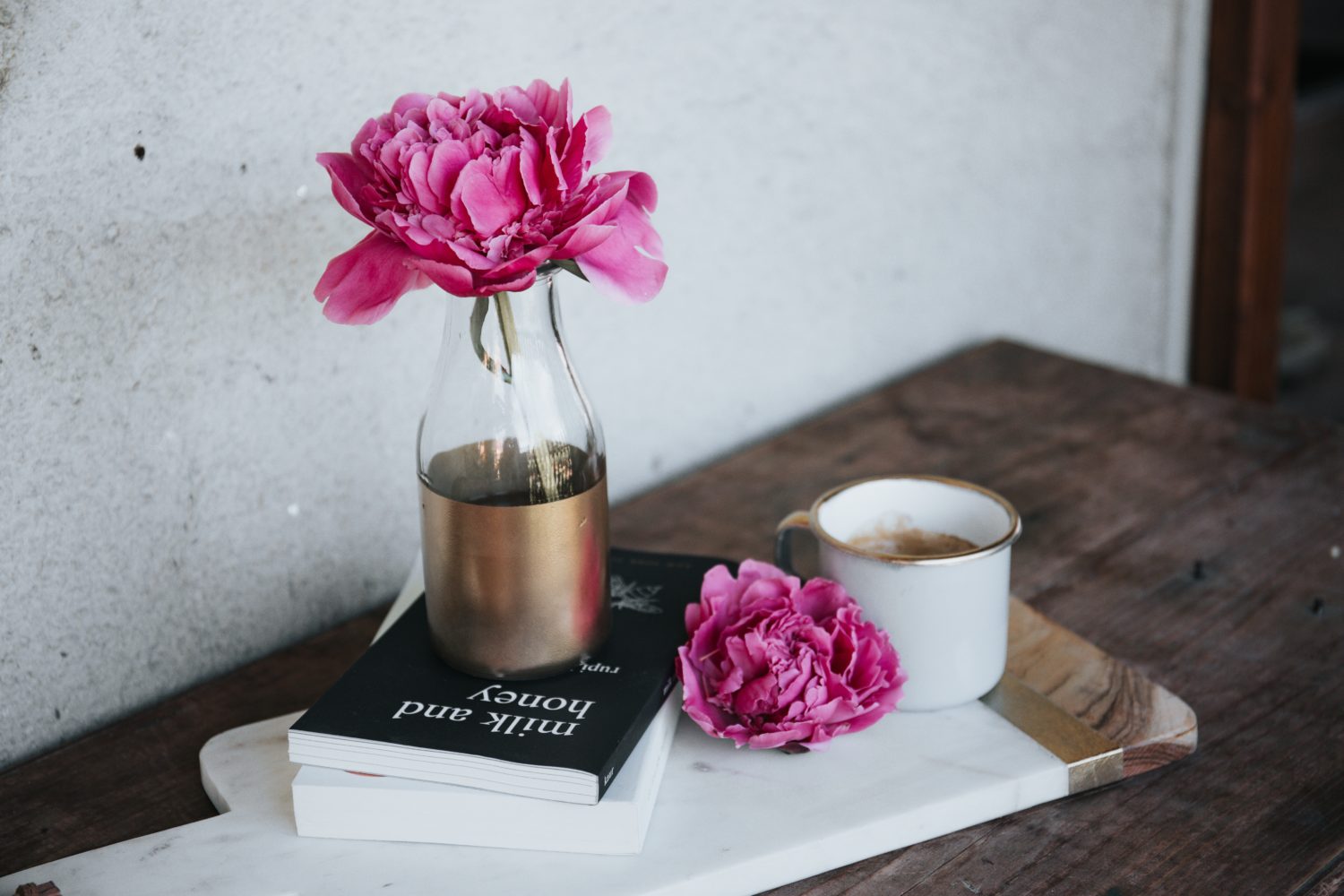 Pink flowers, a book and tea.